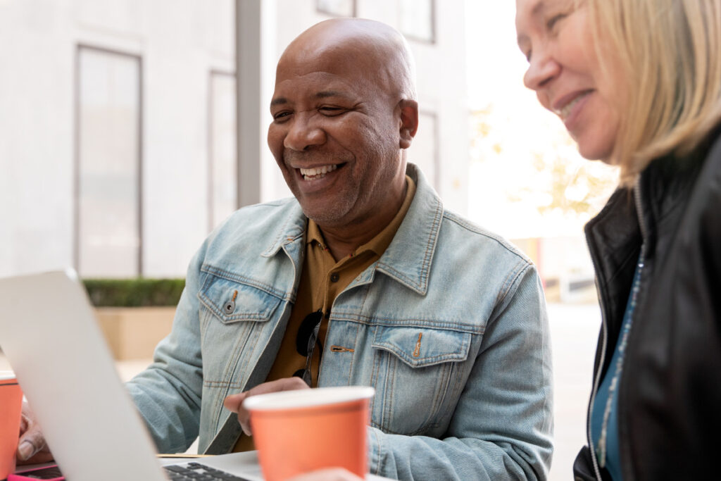 Photo of smiling senior on laptop