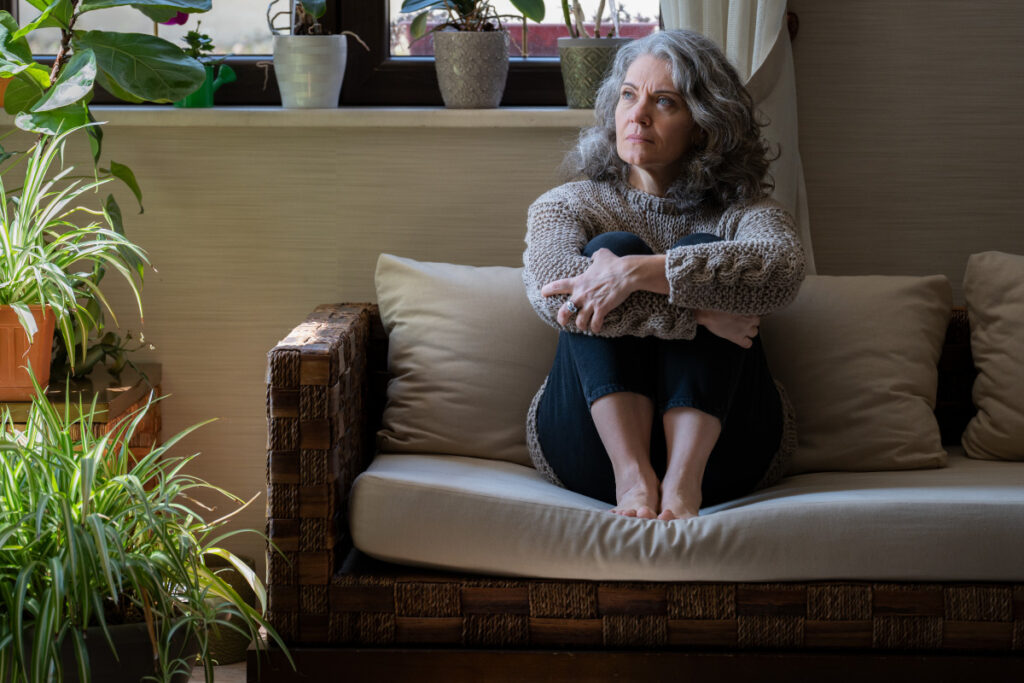 sad elderly woman on sofa